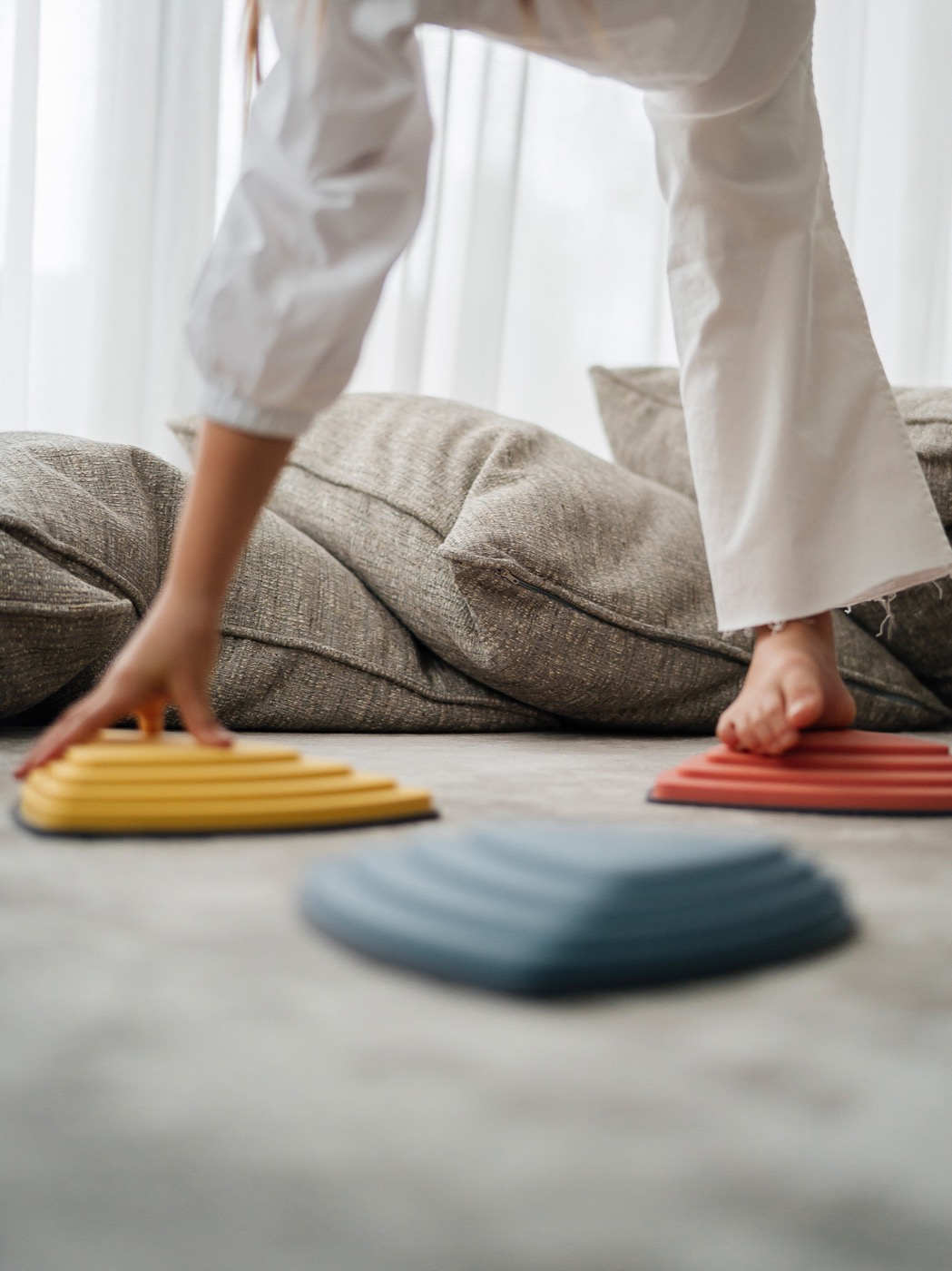Hands supporting a child's foot with a sensory ball